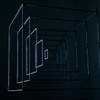 Abstract metal cube installation with glowing edges in a dark room, showcasing geometric art.